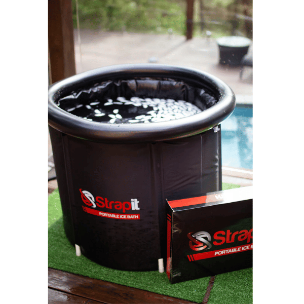 Strapit Portable Ice Bath in black full view on fake grass near a pool