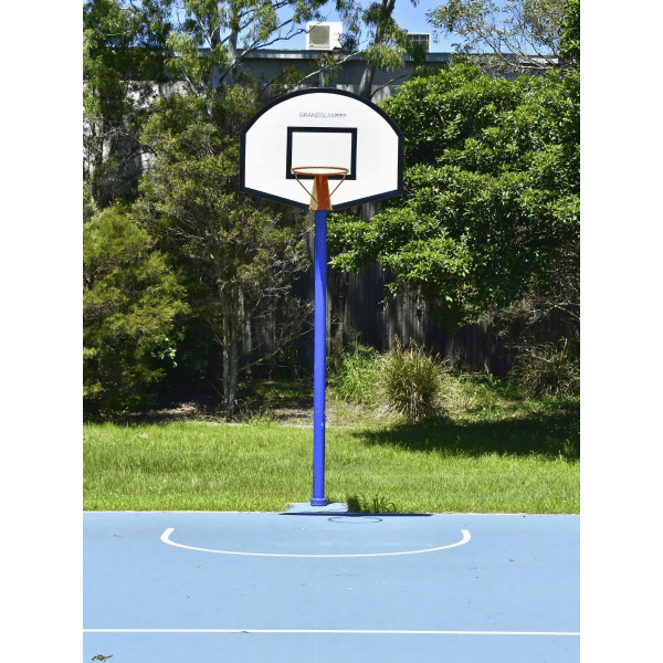 Grand Slam Arched Basketball Tower  on a blue court with trees in the background front facing