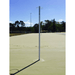 Grand Slam Fixed Netball Post on a netball court with trees and clear sky in the background