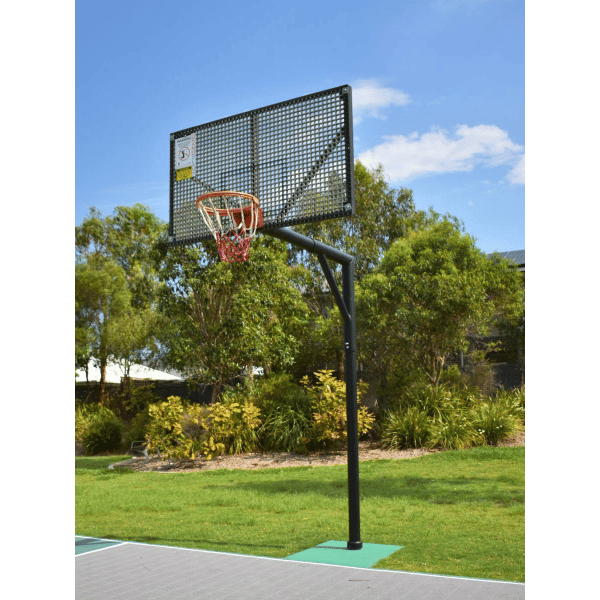 Grand Slam Reversible Basketball Tower on an outdoor court with trees and blue sky in the background