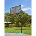 Grand Slam Reversible Basketball Tower on an outdoor court with trees and blue sky in the background