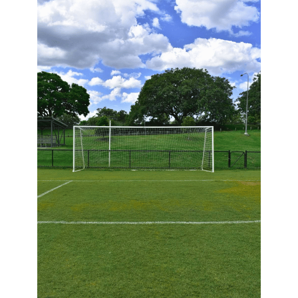 Grand Slam Senior Aluminium Soccer Goals on a grass field with trees and blue sky in the background